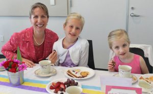 Ladies Sip Tea with Pinky Fingers Down at Etiquette Party