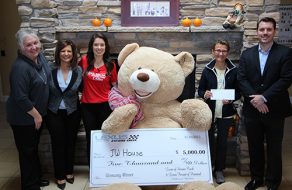 Giant Teddy Bear Delivers $5,000 Check to JW House in a Silver Lexus Convertible