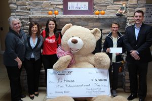 Giant Teddy Bear Delivers $5,000 Check to JW House in a Silver Lexus Convertible