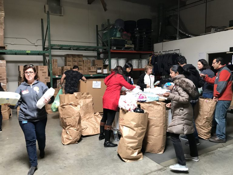 Local Volunteers “Help a Mother Out” by Assembling Diaper Kits