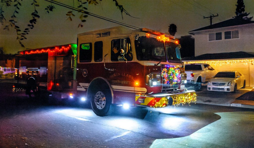 Santa Clara Fire Department fire trucks cruise down Santa Clara streets decked in holiday cheer for children and families.