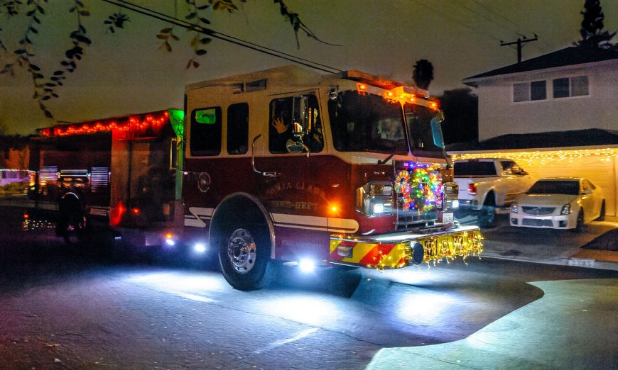 Santa Clara Fire Department fire trucks cruise down Santa Clara streets decked in holiday cheer for children and families.